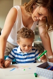 Preschool Teacher Looking at the Kid's Drawing