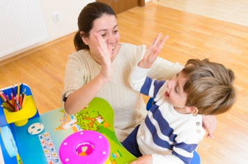 Mother playing with her child and encouraging him