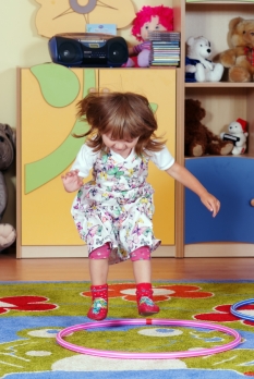 Two-year girl playing and learning in preschool