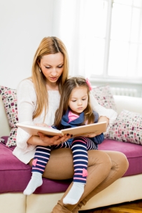 Mother and daughter reading in the room