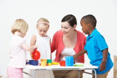 Pre School Children Enjoying Tea Party With Teacher