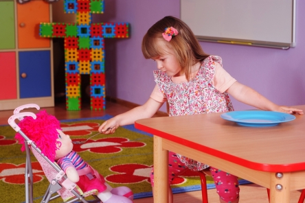 Two-year girl playing and learning in preschool