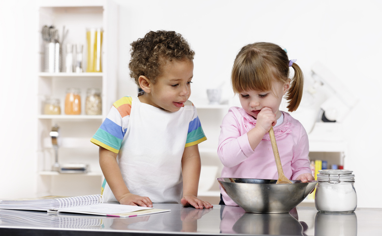 Little Boy And Girl Preparing Food In The Kitchen