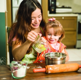 Girl having fun cooking with her mother