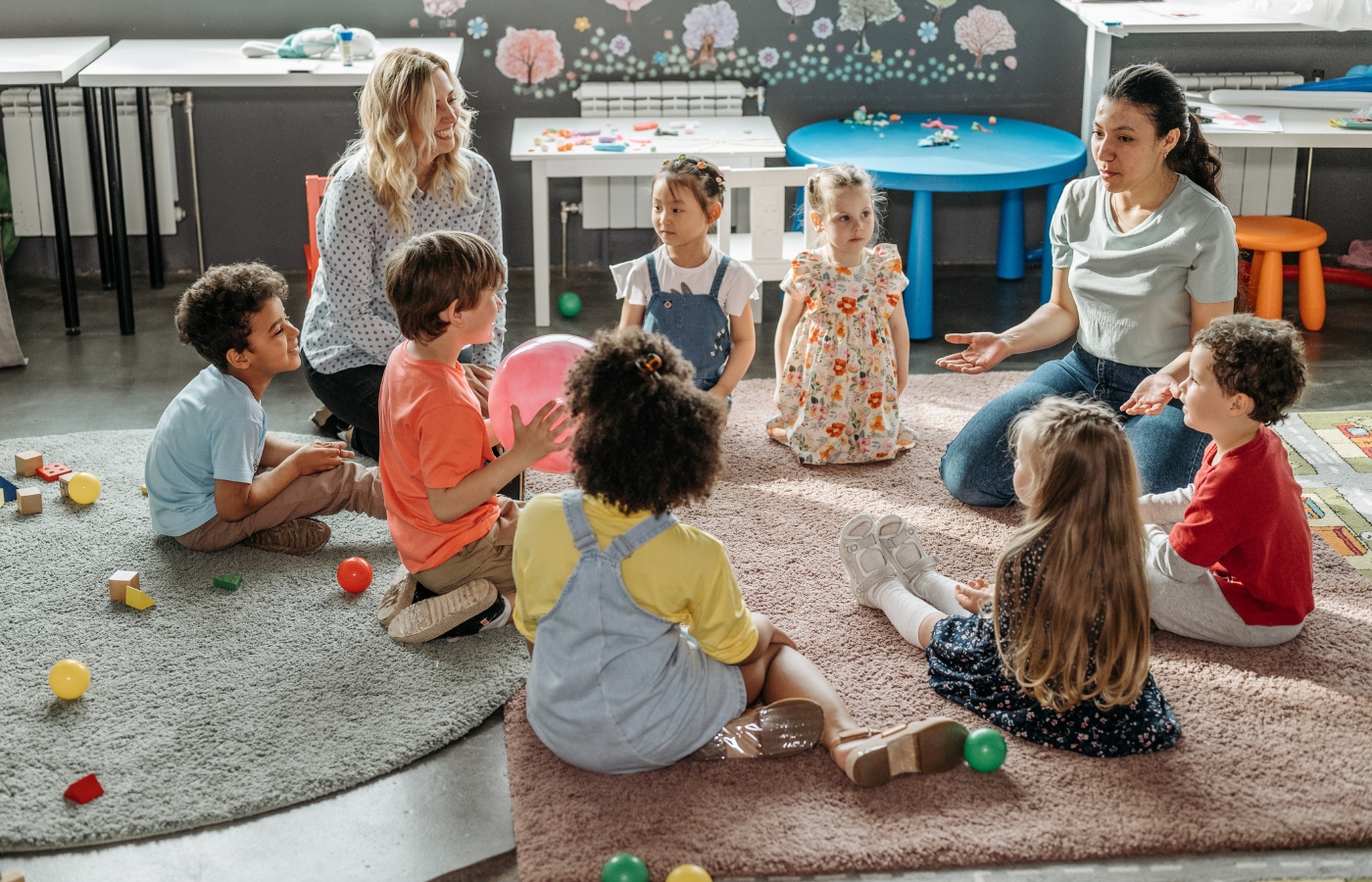 Preschool classroom calmly listening to what their teachers are saying